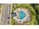 Overhead shot of a community pool and recreation area with lounge chairs, picnic tables, and clubhouse at 2805 Bookmark Dr, Kissimmee, FL 34746