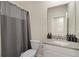 Neutral bathroom with a white vanity, gray countertop, toilet, and gray shower curtain at 2805 Bookmark Dr, Kissimmee, FL 34746