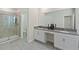 Modern bathroom featuring double vanity, sleek countertops, stylish fixtures, and a glass-enclosed shower at 2805 Bookmark Dr, Kissimmee, FL 34746