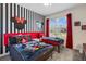 Themed ' bedroom features fun decor, striped accent wall, red accents and a bright window at 2805 Bookmark Dr, Kissimmee, FL 34746