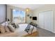 Comfortable bedroom with large window, natural light, and decorative lighting fixture at 2805 Bookmark Dr, Kissimmee, FL 34746