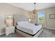 Bedroom showcasing a tufted headboard, carpet floors, and a natural light filled window at 2805 Bookmark Dr, Kissimmee, FL 34746