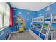 bedroom with bunk beds and walls adorned with cartoon character artwork at 2805 Bookmark Dr, Kissimmee, FL 34746