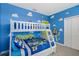 bedroom with bunk beds, bright cartoon-themed decor, and ample space at 2805 Bookmark Dr, Kissimmee, FL 34746