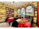 Whimsical bedroom with two twin beds, Gryffindor themed bedding, custom brick wall art, and a magical book shelf at 2805 Bookmark Dr, Kissimmee, FL 34746