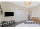 Clean bedroom with double closet, TV, white bedding, and a bench at 2805 Bookmark Dr, Kissimmee, FL 34746