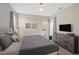 Spacious bedroom with a large bed, dresser, and a glimpse into the bathroom at 2805 Bookmark Dr, Kissimmee, FL 34746