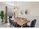 The dining room area features a modern light fixture and view of the backyard at 2805 Bookmark Dr, Kissimmee, FL 34746