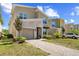 Beautiful home showcasing lush landscaping, paver driveway, and attractive architectural details at 2805 Bookmark Dr, Kissimmee, FL 34746
