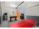 Spacious garage transformed into a game room with foosball, ping pong, and an arcade game at 2805 Bookmark Dr, Kissimmee, FL 34746