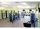 Brightly lit gym featuring a variety of modern exercise equipment and multiple televisions for entertainment at 2805 Bookmark Dr, Kissimmee, FL 34746