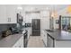 Kitchen with long gray countertops, white cabinets, and black appliances at 2805 Bookmark Dr, Kissimmee, FL 34746