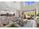 The open-concept living room features high ceilings, pool view and flows into the modern kitchen at 2805 Bookmark Dr, Kissimmee, FL 34746