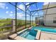 A relaxing pool area with a hot tub in a screened enclosure offers a tranquil space for outdoor enjoyment at 2805 Bookmark Dr, Kissimmee, FL 34746