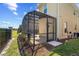 A screened pool enclosure extends from the side of a tan house, providing a private outdoor space at 2805 Bookmark Dr, Kissimmee, FL 34746