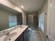 Bathroom featuring double sinks, large mirror, and glass shower stall at 2978 Aqua Virgo Loop # 13, Orlando, FL 32837
