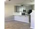 Modern kitchen featuring quartz countertops, stainless steel appliances, and ample cabinet space at 2978 Aqua Virgo Loop # 13, Orlando, FL 32837
