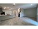 Open-concept living area featuring tile floors and a staircase to the upper level at 2978 Aqua Virgo Loop # 13, Orlando, FL 32837