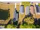 Aerial view of houses with dark roofs, surrounded by greenery and a calm pond at 3063 Jon Jon Ct, Orlando, FL 32822