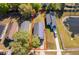 Aerial view of a single-Gathering home with a long driveway and spacious backyard bordered with a red outline at 3063 Jon Jon Ct, Orlando, FL 32822