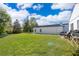 Spacious, fenced-in backyard with healthy green grass and a patio seating area at 3063 Jon Jon Ct, Orlando, FL 32822