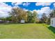 Spacious backyard with lush green grass and mature trees, perfect for outdoor activities at 3063 Jon Jon Ct, Orlando, FL 32822