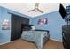 Bedroom featuring blue walls, a ceiling fan, and a bed with a black frame at 3063 Jon Jon Ct, Orlando, FL 32822