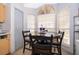 Cozy breakfast nook with wooden table and chairs nestled by a bright window with natural lighting at 3063 Jon Jon Ct, Orlando, FL 32822