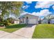 Charming single-Gathering home featuring a well-manicured lawn, arched entry, and attached two-car garage at 3063 Jon Jon Ct, Orlando, FL 32822