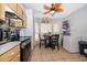 Bright kitchen featuring light wood cabinets, stainless steel appliances, and adjacent breakfast table by windows at 3063 Jon Jon Ct, Orlando, FL 32822