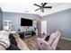 Inviting living room with a contemporary ceiling fan, stylish furniture, laminate floors, and fireplace at 3063 Jon Jon Ct, Orlando, FL 32822