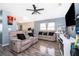 Spacious living room featuring comfortable seating, a modern ceiling fan, and laminate floors at 3063 Jon Jon Ct, Orlando, FL 32822