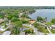 Aerial view showcasing the lakefront property, surrounded by lush greenery and mature trees in a tranquil neighborhood at 3107 Troy Dr, Orlando, FL 32806