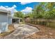 Fenced backyard with mature trees and landscaping offers a private outdoor retreat at 3107 Troy Dr, Orlando, FL 32806