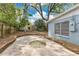 Backyard area features a small patio and lush landscaping, ideal for outdoor relaxation at 3107 Troy Dr, Orlando, FL 32806
