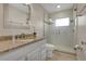 Bright bathroom featuring a vanity with storage and a large shower with glass door at 3107 Troy Dr, Orlando, FL 32806