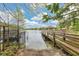 Private boat ramp and wooden dock leading to a gazebo on the serene lake; nature and relaxation combined at 3107 Troy Dr, Orlando, FL 32806