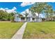 Well-maintained single-story home with a lush lawn and welcoming walkway at 3107 Troy Dr, Orlando, FL 32806