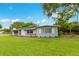 Quaint single-story home with light blue accents and a lush green lawn at 3107 Troy Dr, Orlando, FL 32806
