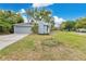 A suburban home featuring an attached garage, tidy landscaping, and a freshly painted exterior at 3107 Troy Dr, Orlando, FL 32806