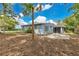 Charming home features a large backyard with mature trees and patio area at 3107 Troy Dr, Orlando, FL 32806