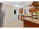 Well-lit kitchen with stainless steel appliances, granite countertops, and convenient access to the outdoors at 3107 Troy Dr, Orlando, FL 32806