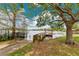 Scenic lake view featuring a private wooden dock with gazebo, mature trees, and a glimpse of the calm waters at 3107 Troy Dr, Orlando, FL 32806