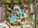 Overhead shot of community pool featuring winding water features, landscaping, and many lounge chairs at 3132 Calabria Ave, Davenport, FL 33897