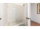 Bathroom shower and tub with white tiling and shower curtain at 3132 Calabria Ave, Davenport, FL 33897