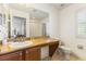 Updated bathroom features a granite countertop, ample storage, and a window at 3132 Calabria Ave, Davenport, FL 33897