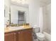 Bathroom with brown vanity and framed mirror at 3132 Calabria Ave, Davenport, FL 33897