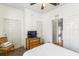 Bright bedroom features a ceiling fan, tv, and natural light at 3132 Calabria Ave, Davenport, FL 33897