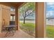 Covered patio features a table with seating and a view of a grassy area at 3132 Calabria Ave, Davenport, FL 33897