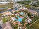 Aerial view of resort-style community pool with lazy river and amenities at 3132 Calabria Ave, Davenport, FL 33897